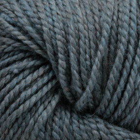 Close-up image of thick, multi-ply Acadia by The Fiber Company yarn in a muted blue-gray color. The yarn strands, tightly twisted together, reveal a textured and slightly fuzzy appearance with a subtle tweed effect from The Fibre Co. (UK) Ltd.