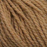 Close-up image of a ball of Harrisville Designs' Harrisville Highland - Cones yarn. The fibers are twisted into thick strands, showing their soft and fuzzy texture. The color is consistent throughout, with a warm, natural tone that suggests the presence of spinning oils.