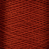 Close-up image of a spool of 10/2 Pearl Cotton Yarn on a mini-cone by Supreme Corp. The yarn is neatly wound in overlapping layers, creating a textured and uniform pattern. The rich red color is consistent throughout, ensuring colorfastness and giving the mini-cone a vibrant and visually appealing appearance.