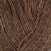 Close-up of Einband Lopi fibers by Berroco, Inc., tightly wound into a skein. The texture appears slightly rough with interwoven strands creating a crisscross pattern. The yarn has a natural, earthy tone with a few lighter fibers mixed in, perfect for stranded colorwork projects.