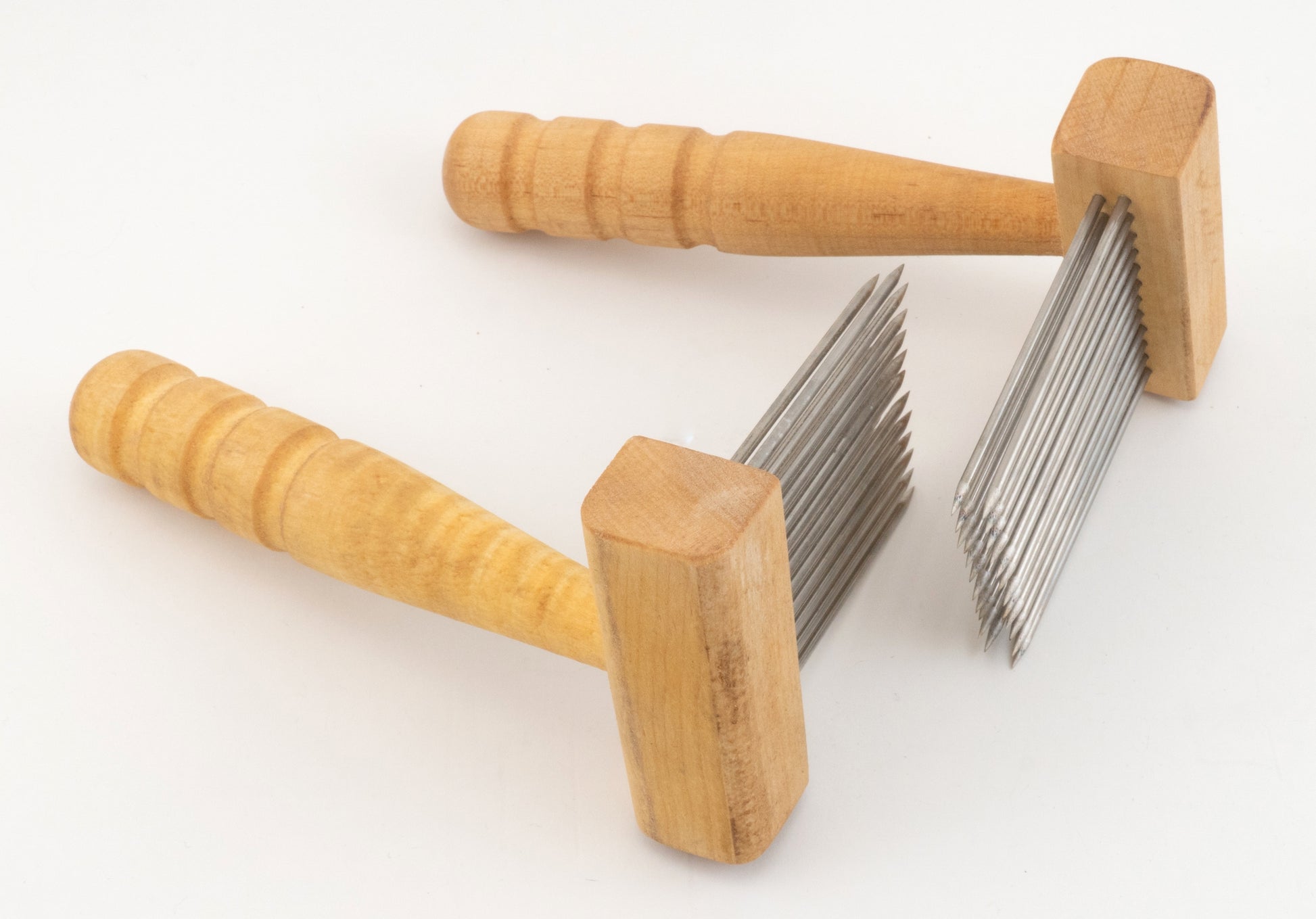 Two Acorn Petite Combs by Sunrise Metal Works, featuring wooden handles and rows of sharp metal teeth, are pictured against a plain white background. These petite single-row combs are designed for specialized tasks such as carding medium coarser wools or needle felting in textile processing.