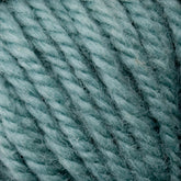 A close-up image of textured Halcyon Yarn Classic Rug Wool from Caledonian Dye Works in a teal blue color, showcasing its twisted fibers and soft fluffy texture. The yarn appears thick, ideal for knitting or crocheting cozy garments or accessories. Its resemblance to Classic Rug Wool makes it a favorite among rug weavers for its durability and charm.

