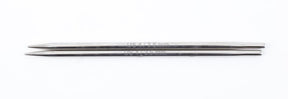 Two sleek, double-pointed metal knitting needles, resembling hollow brass pipes, are laid together on a white background. One needle features an engraved measurement reading "US 4 / 3.5 mm," highlighting the craftsmanship of Accessories Unlimited's Nova Platina Interchangeable Knitting Needles, 4.5" Tip.