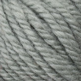 A close-up image of Halcyon Yarn Classic Rug Wool in light grey from Caledonian Dye Works. The thick strands are tightly twisted together, creating a soft, woolly texture. The yarn's fibers are slightly fuzzy, giving it a cozy and warm appearance—perfect for hand-dye projects or use in rug weaving.

