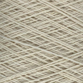 Close-up image of JaggerSpun Heather 3/8 wool yarns from Jagger Brothers, Inc. neatly wound into a ball. The beige-colored strands are tightly arranged in a crisscross pattern, highlighting the texture and fine fibers of the worsted spun yarn.