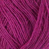 Close-up image of Berroco, Inc.'s Einband Lopi yarn in a vibrant magenta hue, showcasing its tightly wound strands and soft texture, perfect for lace knitting or crocheting projects.