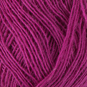 Close-up image of Berroco, Inc.'s Einband Lopi yarn in a vibrant magenta hue, showcasing its tightly wound strands and soft texture, perfect for lace knitting or crocheting projects.