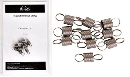 A package from Ashford Handicrafts Limited, labeled "Ashford E-Spinner 3 Tension Spring (Small)," features a white design with a clear window displaying coiled metal springs inside. Beside the package, several loose coiled springs are scattered, perfect for use as replacement tension springs for your Ashford E-Spinner or Espinner 3.