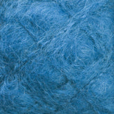 Close-up of a ball of fluffy, Victorian Brushed Mohair Yarn in a stunning blue hue. Made from luxurious mohair by Caledonian Dye Works, this mini skein features a soft, fuzzy texture with various shades of blue interwoven for a rich, tactile appearance. The delicate and slightly wavy fibers create a cozy and inviting visual effect.