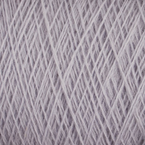 Close-up image of a JaggerSpun Maine Line 2/20 Yarn large cone by Jagger Brothers, Inc. showcasing a detailed, crisscrossing pattern of the light gray yarn strands. The texture appears soft and slightly fuzzy, indicating it is made from medium grade wool, ideal for knitting or crocheting projects. Perfect for those who appreciate high-quality fibers.