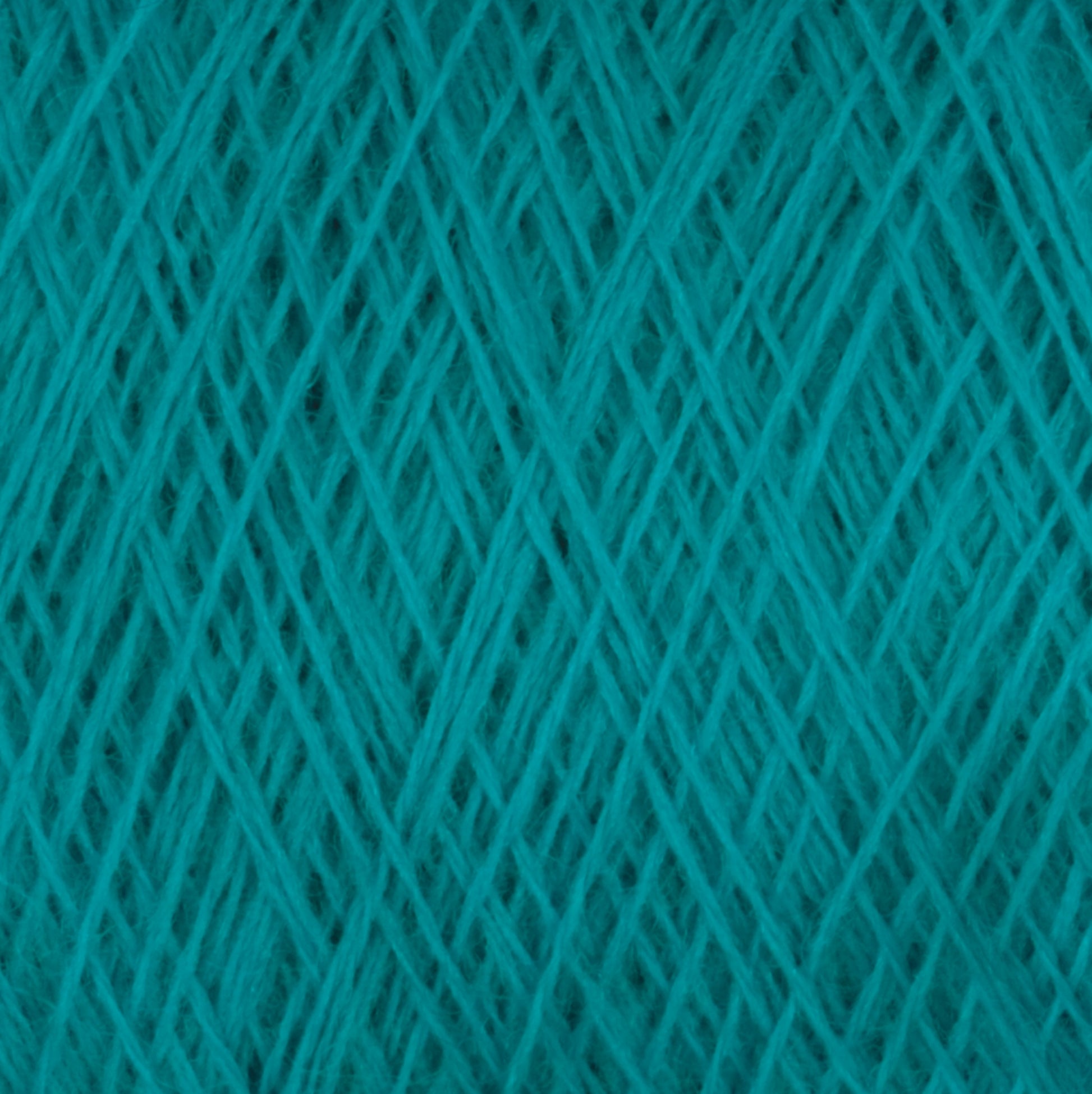 Close-up image of a tightly wound ball of teal JaggerSpun Maine Line 2/20 Yarn | Large Cone by Jagger Brothers, Inc., showing the intricate crisscross patterns of the fibers. The texture is soft and slightly fuzzy, and the vibrant teal color is consistent throughout.