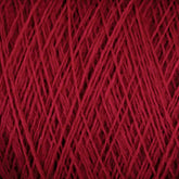 Close-up of a ball of JaggerSpun Maine Line 3/8 Yarn by Jagger Brothers, Inc. The tightly wound threads create a detailed, crisscrossing pattern with visible texture. The yarn appears soft and thick, suggesting it may be suitable for knitting or crocheting projects using this high-quality, worsted spun yarn available in large cones.