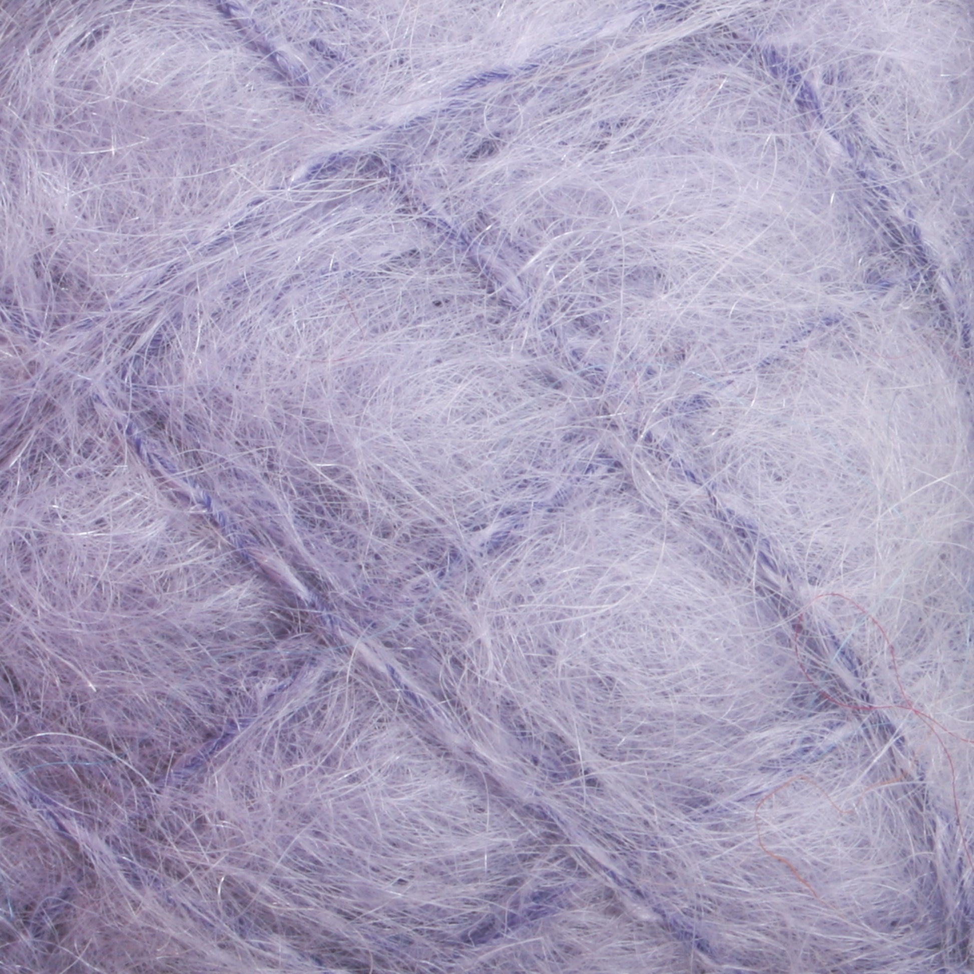 A close-up view of a fuzzy, light purple yarn from Caledonian Dye Works' Victorian Brushed Mohair Yarn. The fine and soft fibers create a fluffy, almost cloud-like texture. Subtle changes in shades throughout the luxurious mohair give it depth and a slightly iridescent appearance.