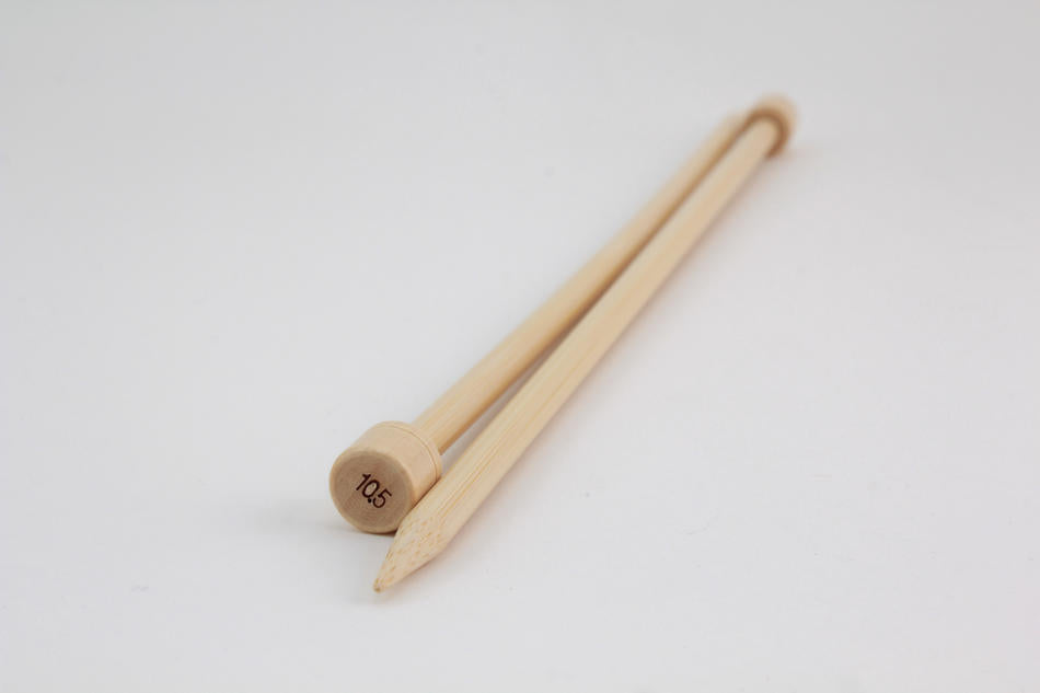 A pair of Accessories Unlimited Bamboo Single-Point Knitting Needles, measuring 12", with one pointed end and the other capped with a circular stopper marked "10.5," are positioned diagonally against a plain white background.