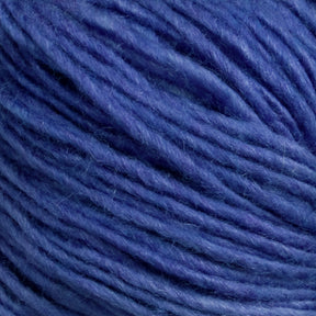 Close-up of a ball of Malabrigo Silky Merino yarn by Malabrigo Yarn, featuring varying shades of blue that create a textured, fibrous appearance. The image highlights the intertwined strands, showcasing the soft and fluffy nature typical of luxury yarn, making it ideal for knitting or crocheting projects.