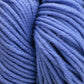 A skein of Plymouth Select Worsted Merino Superwash from Plymouth Yarn Co., in a deep purple hue, is coiled into an oval shape. The soft, twisty texture, enhanced by the superwash treatment, makes it perfect for knitting or crocheting projects. The plain white background highlights the rich color and impeccable stitch definition of this high-quality yarn.