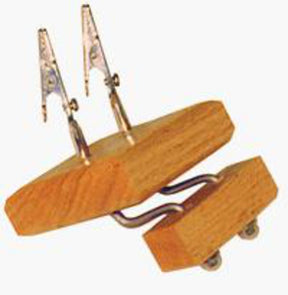 The Shadybrook Fringe Twister from Shadybrook Farm is a wooden device featuring two metal alligator clips attached to flexible arms. The base comprises two wooden blocks connected by a metal spring. This fringing gadget serves as a helping hand tool, commonly used for holding small objects in place while making rugs or scarves.