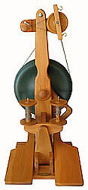 The Majacraft Suzie Spinning Wheel by Majacraft Co. features a green lacquered wheel, two foot pedals, and various components designed for spinning fiber into yarn. This upright wooden spinning wheel boasts intricate detailing with a traditional design ideal for crafting textiles and ensuring smoother spinning action.