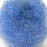 A close-up view of a tangled ball of blue steel wool against a white background. The strands, reminiscent of Harrisville Designs' Dyed & Carded Wool Fiber, are densely packed, creating a textured, fibrous appearance.