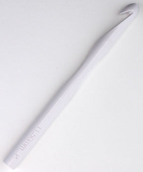 The Skacel Large Plastic Crochet Hook, sized at 11.50 mm, is displayed against a plain background. This white crochet hook features a smooth, slightly ergonomic handle that tapers towards the hooked end, making it ideal for working with bulky or jumbo yarns.