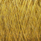 Close-up image of yellow Harrisville Highland - Cones yarn from Harrisville Designs, showcasing a textured and intertwined pattern. The fibers appear soft and slightly fuzzy, capturing the intricate details of the woven threads.