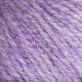 Close-up image of soft, textured purple and light lavender yarn. The interwoven fibers create a fluffy appearance, showcasing heathered colors within the twisted strands. Bartlettyarns Maine Wool Yarn by Bartlettyarns gives it a cozy and warm feel, ideal for knitting or crocheting projects.