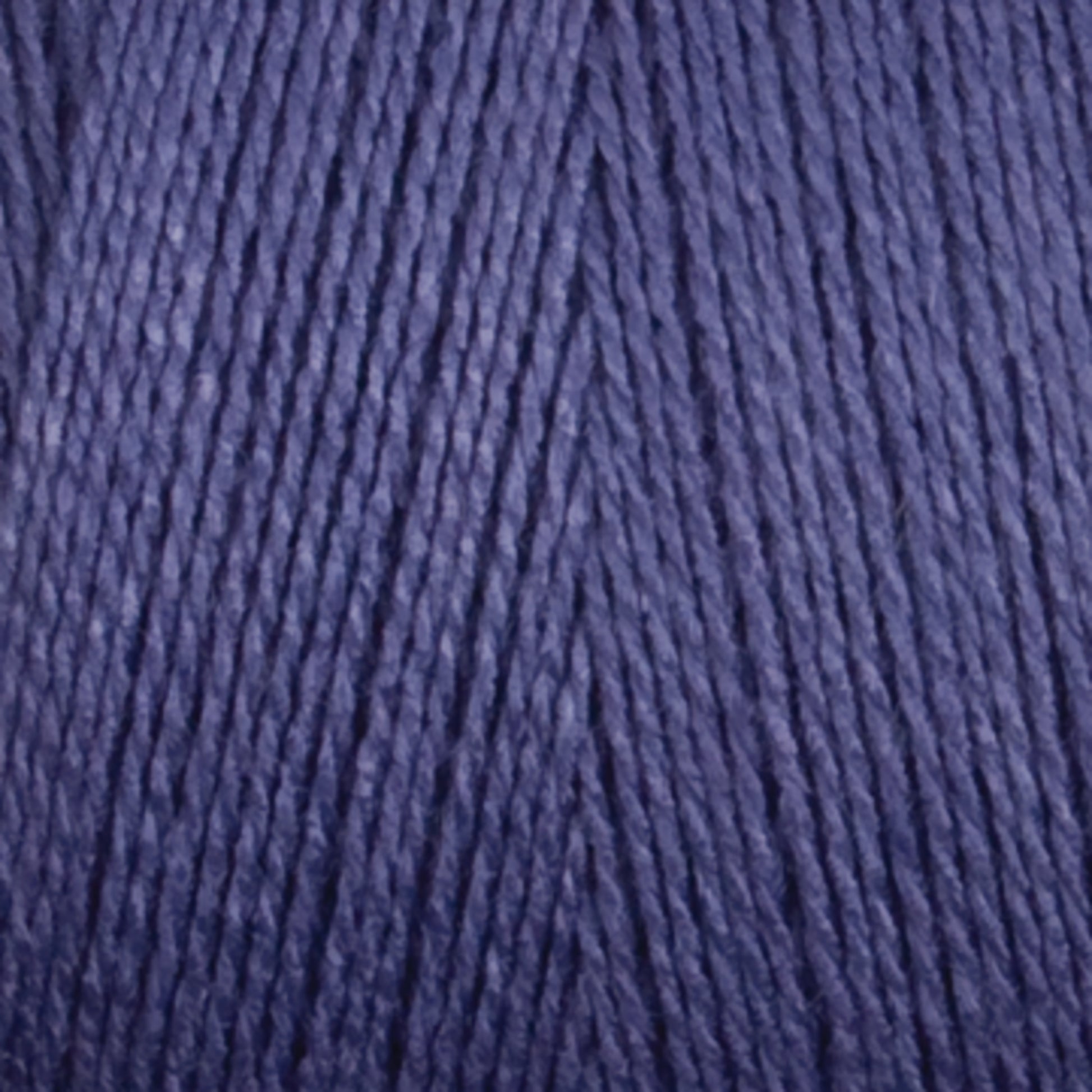 A close-up image of Maurice Brassard's 16/2 Bamboo Yarn in deep purple, wound tightly. The yarn exhibits a slightly shiny texture, with individual strands twisted together to create a textured pattern. This sustainable material not only boasts rich color but also features natural antibacterial properties.