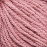 Close-up shot of Halcyon Deco Rug Wool from Caledonian Dye Works, showcasing its soft, pink yarn tightly wound in neat strands that highlight its fuzzy texture and detailed fibers. Made from 100% wool, this versatile yarn is perfect for crafting cozy garments or deco rug projects.