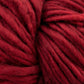 Close-up of thick, plush crimson red Malabrigo Mecha superwash bulky yarn. The strands are tightly wound, showcasing the soft and slightly fuzzy texture of this kettle dyed yarn. The rich, warm color is consistent throughout the image, highlighting the intricate detailing of the fibers by Malabrigo Yarn.