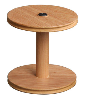 The Ashford Jumbo Bobbin by Ashford Handicrafts Limited features a large wooden spool design with a central cylindrical core, flanked by two flat circular discs. It boasts a light wood color and includes a small black button-like feature in the center of the top disc.