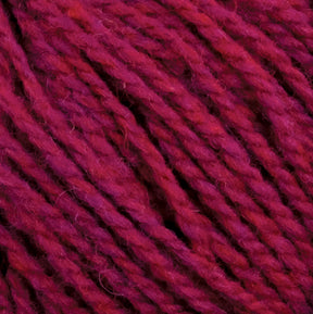 Close-up of several strands of deep red Harrisville Highland - Cones yarn by Harrisville Designs, showing their texture and slight variations in color. The thick, tightly twisted strands appear soft and plush, likely treated with spinning oils.