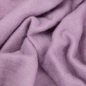 A close-up view of Europa Wools Ltd's soft, lilac-colored Merino Prefelt with gentle folds and a slightly fuzzy texture. The material appears cozy and plush, evoking a sense of warmth and comfort—ideal for nuno felting enthusiasts.