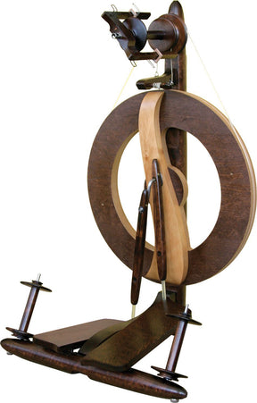 The Kromski Fantasia Spinning Wheel by Kromski North America boasts a modern and sleek vertical design crafted from wood and metal. It features a large circular wheel, a foot pedal, and several mechanisms for yarn spinning, including the efficient single drive flyer design. The overall construction appears sturdy and well-crafted.