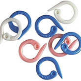 A collection of Bryson Distributing, Inc. Clover Split Ring Stitch Markers, perfect for knitting accessories, in the shape of hooks. The markers are blue, pink, and white and are arranged in a scattered manner on a white background. The hooks feature a small hole near the tip for attaching to yarn.