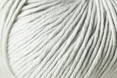 Close-up image of a ball of soft, thick, light grey Jo Sharp Soho Summer DK Cotton yarn from Kingfisher Yarn & Fibre. The yarn strands are neatly wound and appear smooth and slightly shiny, indicating a high-quality material. The texture is prominently displayed, showcasing the tight twisting of the threads.