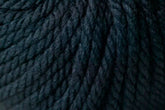 Close-up image of tightly wound, dark navy blue Jo Sharp Silkroad Ultra yarn by Kingfisher Yarn & Fibre displaying its detailed texture and thickness. The super soft strands appear fibrous and intertwined to form a solid, uniform surface—ideal for crafting cozy winter accessories.