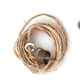 A Kromski Brake Band Set from Kromski North America lies on a white surface, featuring a coiled rope with a dark cylindrical weight in the center, a metal washer, and a metal eye hook. Additionally, off to the side, there is also a visible blue metal eye hook.