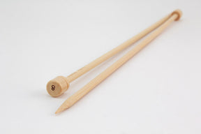 A pair of Accessories Unlimited Bamboo Single-Point Knitting Needles, 12", against a white background. One knitting needle is pointing to the left with its tip visible, while the other is pointing right with a rounded end displaying the number "8".