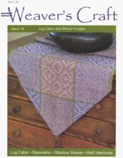 Cover of Weaver's Craft Issue 19: Log Cabin and Where It Leads by Plain Tabby Press. The magazine showcases a woven tablecloth with intricate patterns draped over a wooden dresser, with a dark bowl placed on top. The cover highlights topics such as log cabin weave, Shadow Weave, Ripmatta, and Weft Interlocks in weaving projects.