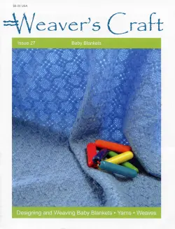 Cover of "Weaver's Craft Issue 27: Baby Blankets" by Plain Tabby Press. The cover displays a patterned blue handwoven baby blanket adorned with several colorful plastic baby toys. The bottom banner reads: "Designing and Weaving Baby Blankets • Yarn Choices • Weaves.