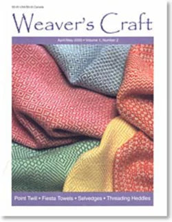 Cover of Weaver's Craft Issue 2: Point Twills, published by Plain Tabby Press. The April/May 2003 cover showcases intricately designed folded woven fabrics in an array of colors: green, blue, red, and yellow. The featured text highlights topics including "Point Twill," "Colorful Fiesta Towels," "Smiling Selvedges," and "Threading Heddles.