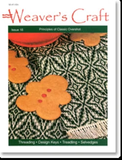 Cover of "Weaver's Craft Issue 18: Principles of Classic Overshot" by Plain Tabby Press. It showcases a black and white woven textile with an intricate geometric pattern, adorned with gingerbread cookies on top. Topics featured include Threading, Design Keys, Treadling, Selvages, and techniques for using an overshot loom to create symmetrical patterns.