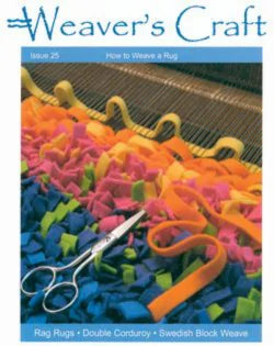 Cover of Weaver's Craft Issue 25: How to Weave a Rug by Plain Tabby Press. Features a close-up of a handloom with colorful fabric strips in shades of yellow, pink, orange, blue, and green. A pair of scissors is placed on the fabric, perfect for your next rug weaving project.