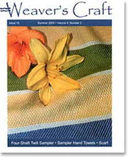 Cover of Weaver's Craft magazine issue 13, Summer 2003, Volume 4, Number 2. The cover features a yellow and an orange lily resting on a woven textile with green, blue, and beige stripes. Text at the bottom reads: "Four-Shaft Twill Threadings - Sampler Hand Towels - Scarf," showcasing inspiring weaving projects by Plain Tabby Press.