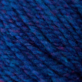 A close-up of Bartlett Maine Wool, Sport Weight Cones by Bartlettyarns shows dark blue yarn with purple and reddish fibers, creating a homespun appearance. Its soft, fuzzy texture and tightly twisted strands form a consistent pattern.