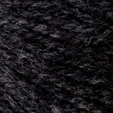 A close-up of Bartlettyarns' Bartlett Maine Wool, Sport Weight Cones showcases tightly wound dark gray yarn in various shades and textures. The cozy fibers give a homespun, slightly heathered look with subtle tonal variations.