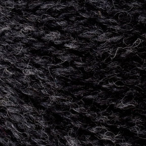 A close-up of Bartlettyarns' Bartlett Maine Wool, Sport Weight Cones showcases tightly wound dark gray yarn in various shades and textures. The cozy fibers give a homespun, slightly heathered look with subtle tonal variations.