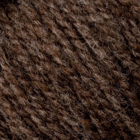 Close-up texture of Bartlett Maine Wool, Sport Weight Cones by Bartlettyarns shows interwoven dark and light brown fibers. Its homespun look suggests a thick and warm material perfect for knitting or crocheting, with a surface that is soft yet slightly coarse, ideal for sport weight projects.