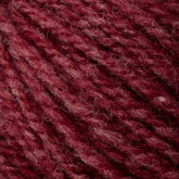 Close-up of Bartlett Maine Wool from Bartlettyarns shows soft, textured yarn in deep burgundy. The sport weight fibers are interwoven with a homespun appearance, creating a cozy and tactile feel.